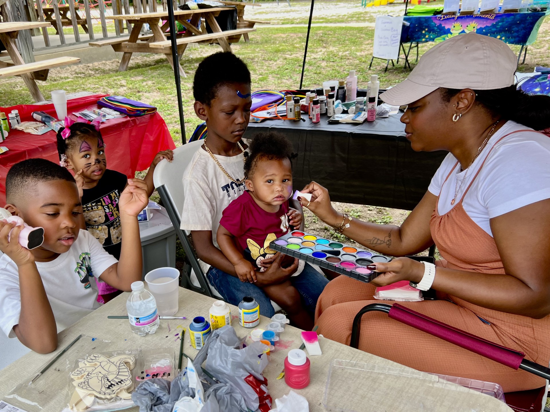 Face painting at a family outdoor event. Face painting at a family outdoor event.
