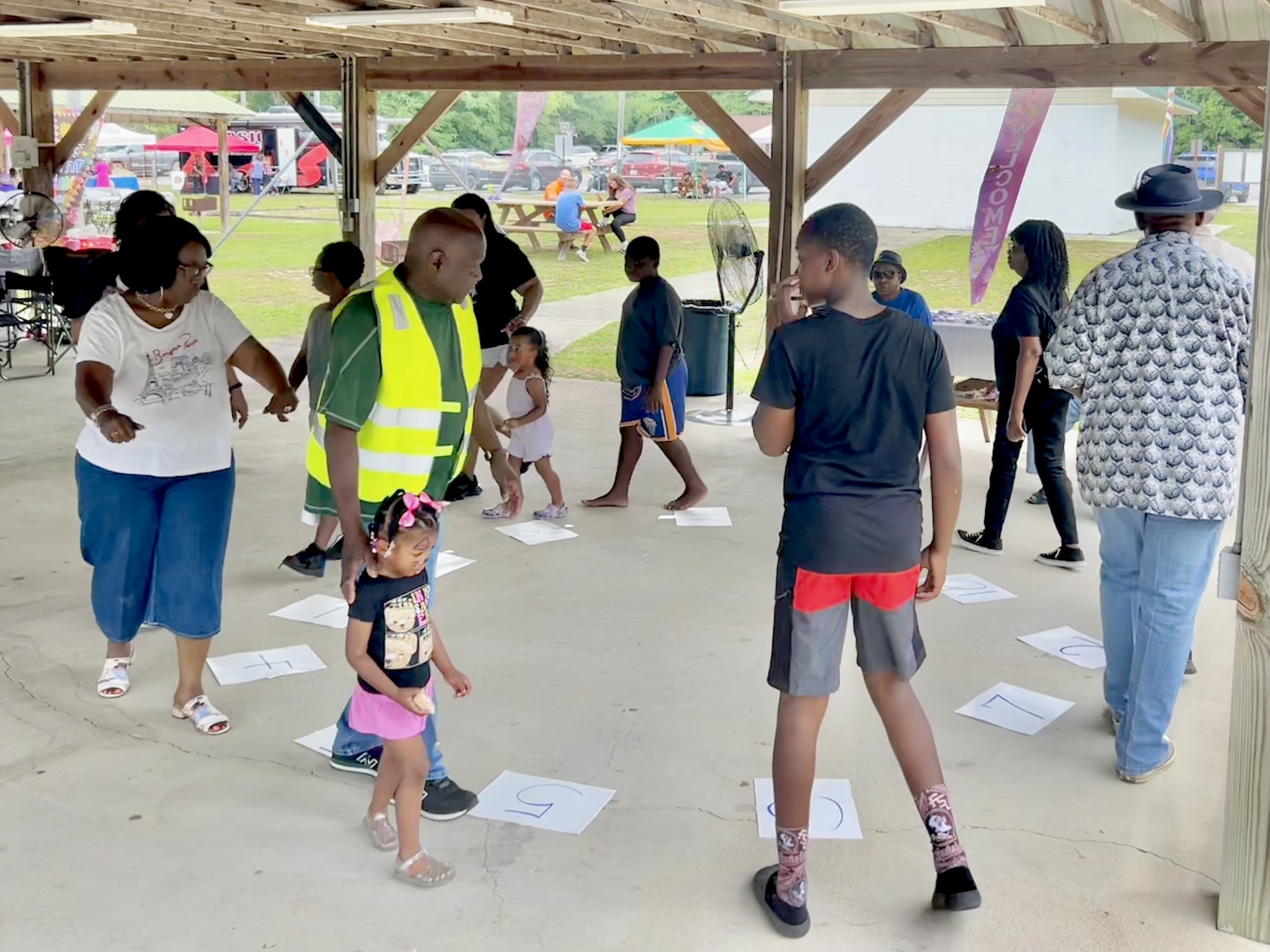 People playing a game under a pavilion. People playing a game under a pavilion.