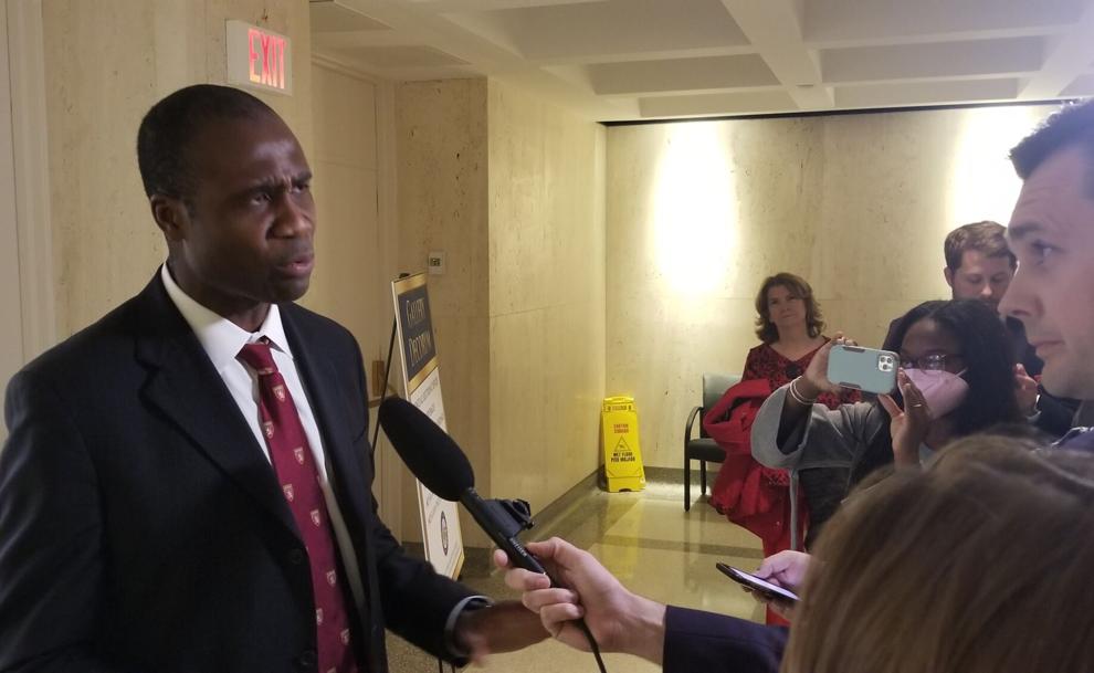 Man speaking to reporters with microphones. Man speaking to reporters with microphones.