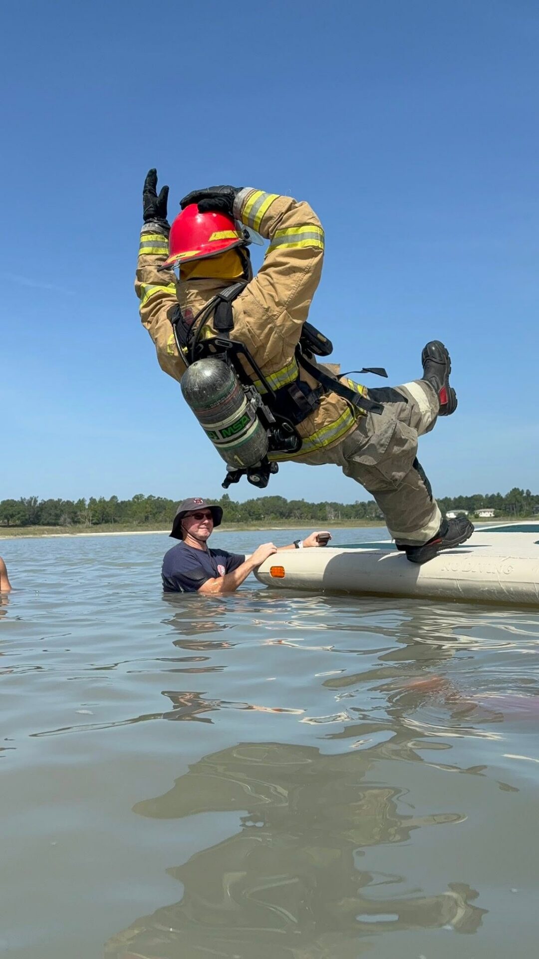 Firefighter jumping into water from boat. Firefighter jumping into water from boat.