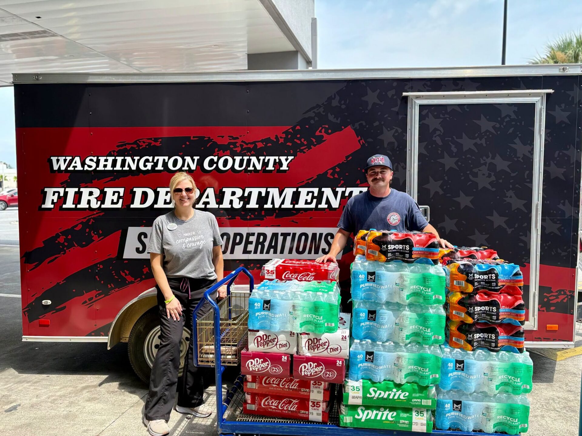 Two people with fire department supply trailer. Two people with fire department supply trailer.